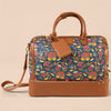 Floral-patterned handbag with brown leather accents on a beige background